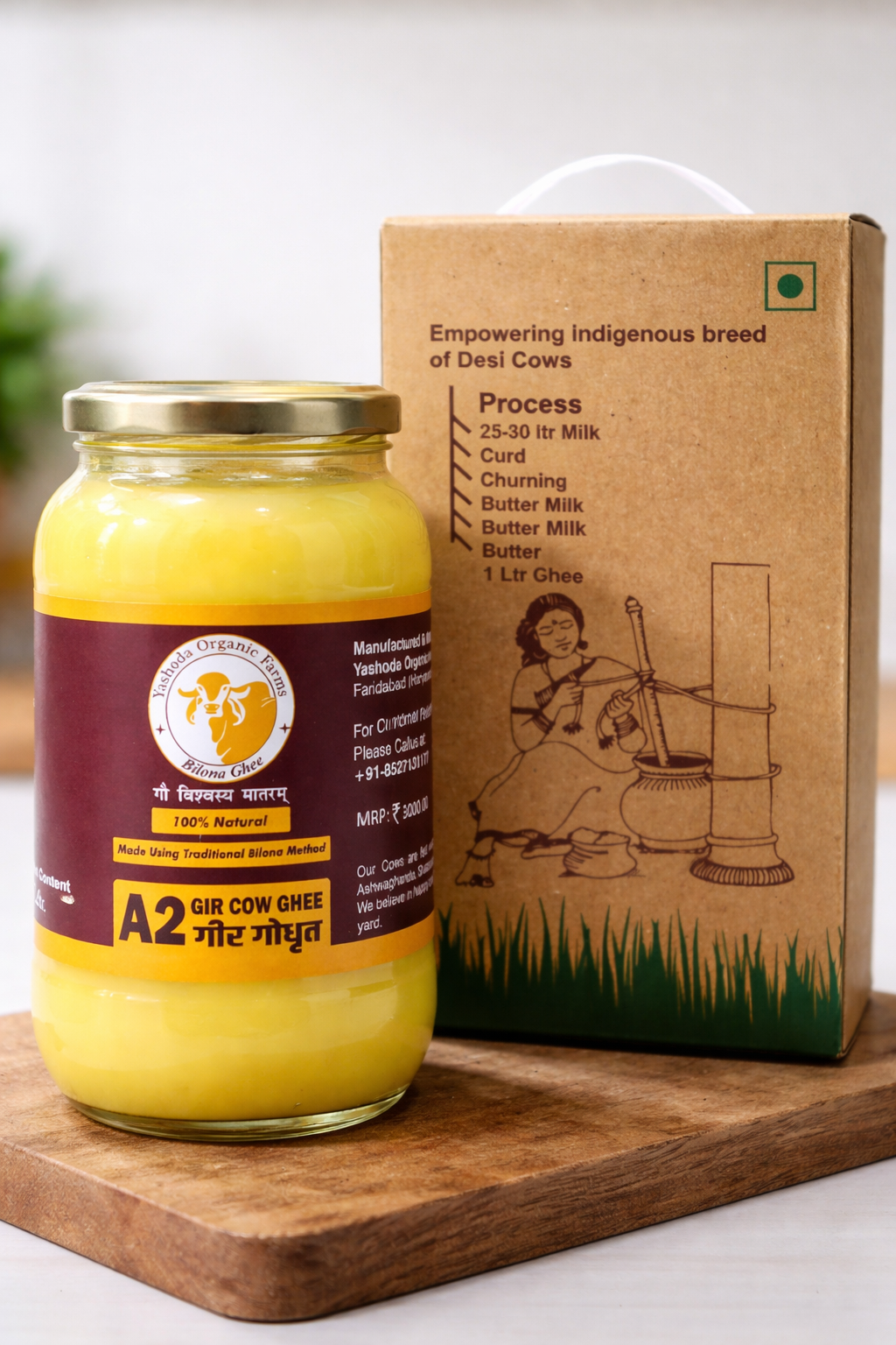 Jar of A2 Gir Cow ghee with a cardboard box on a wooden board